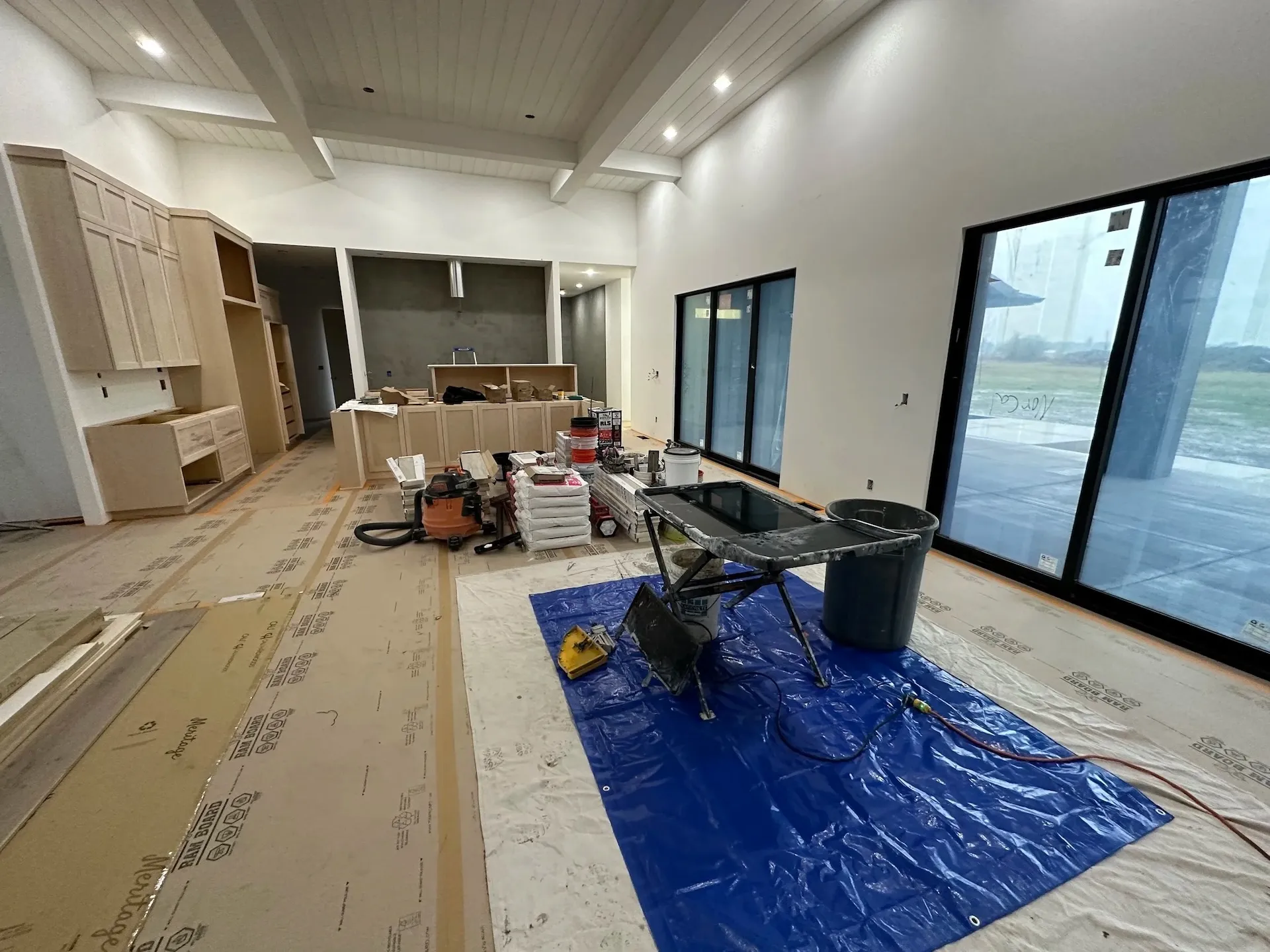 Modern home interior under construction with vaulted ceiling and large sliding doors