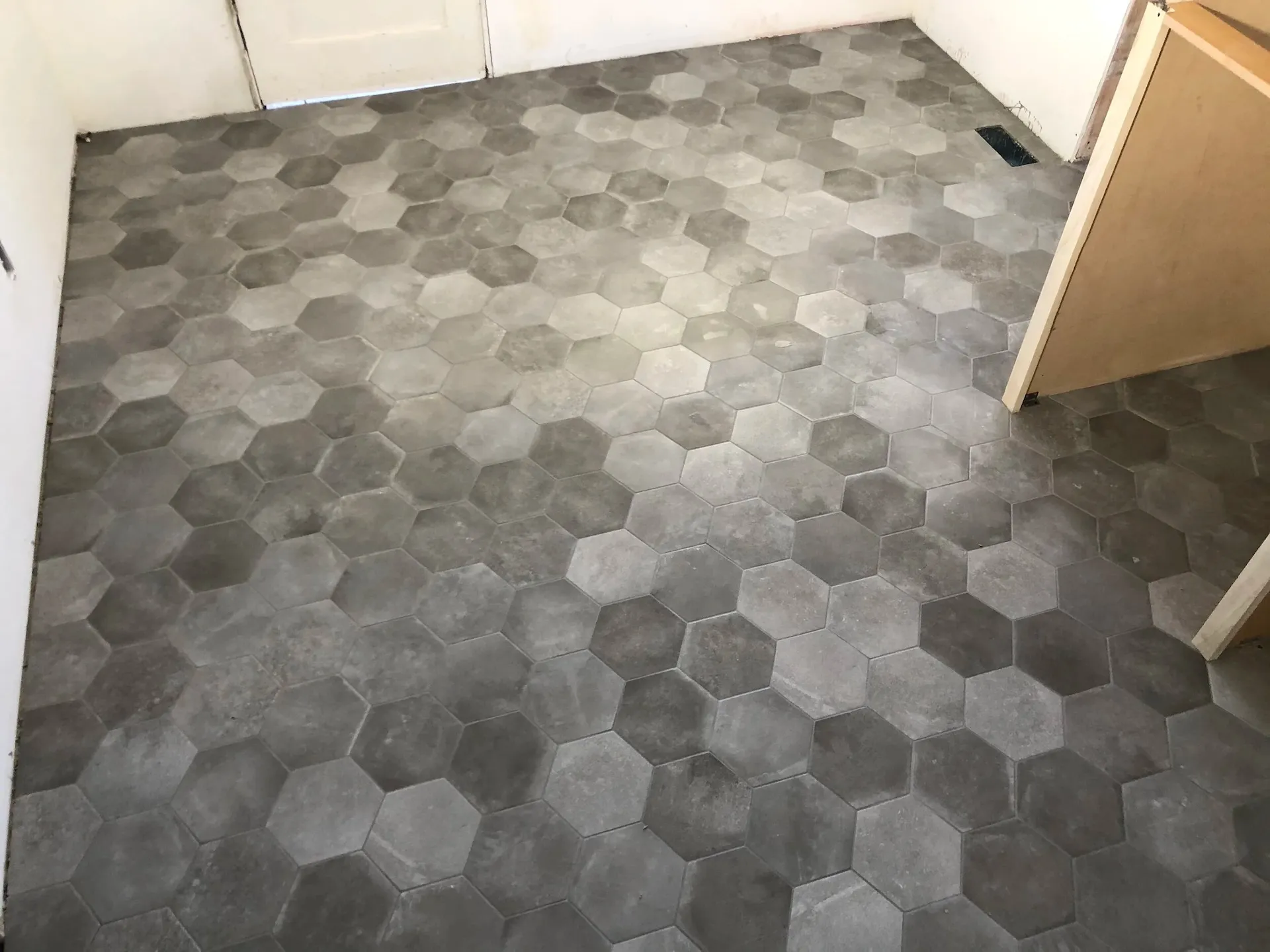 Gray hexagon floor tiles in mixed tones with modern geometric pattern