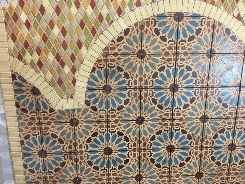 image-asset-56 Decorative mosaic tile arch featuring colorful geometric patterns and handcrafted Mediterranean-inspired ceramic designs