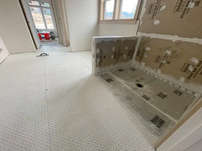 image-asset-65 Waterproof bathroom shower installation with Schluter shower pan, bench seating, and uncoupling membrane flooring system